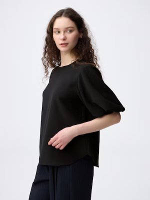 Model wearing a black women's utility blouse with mid-length sleeves shown from the side.