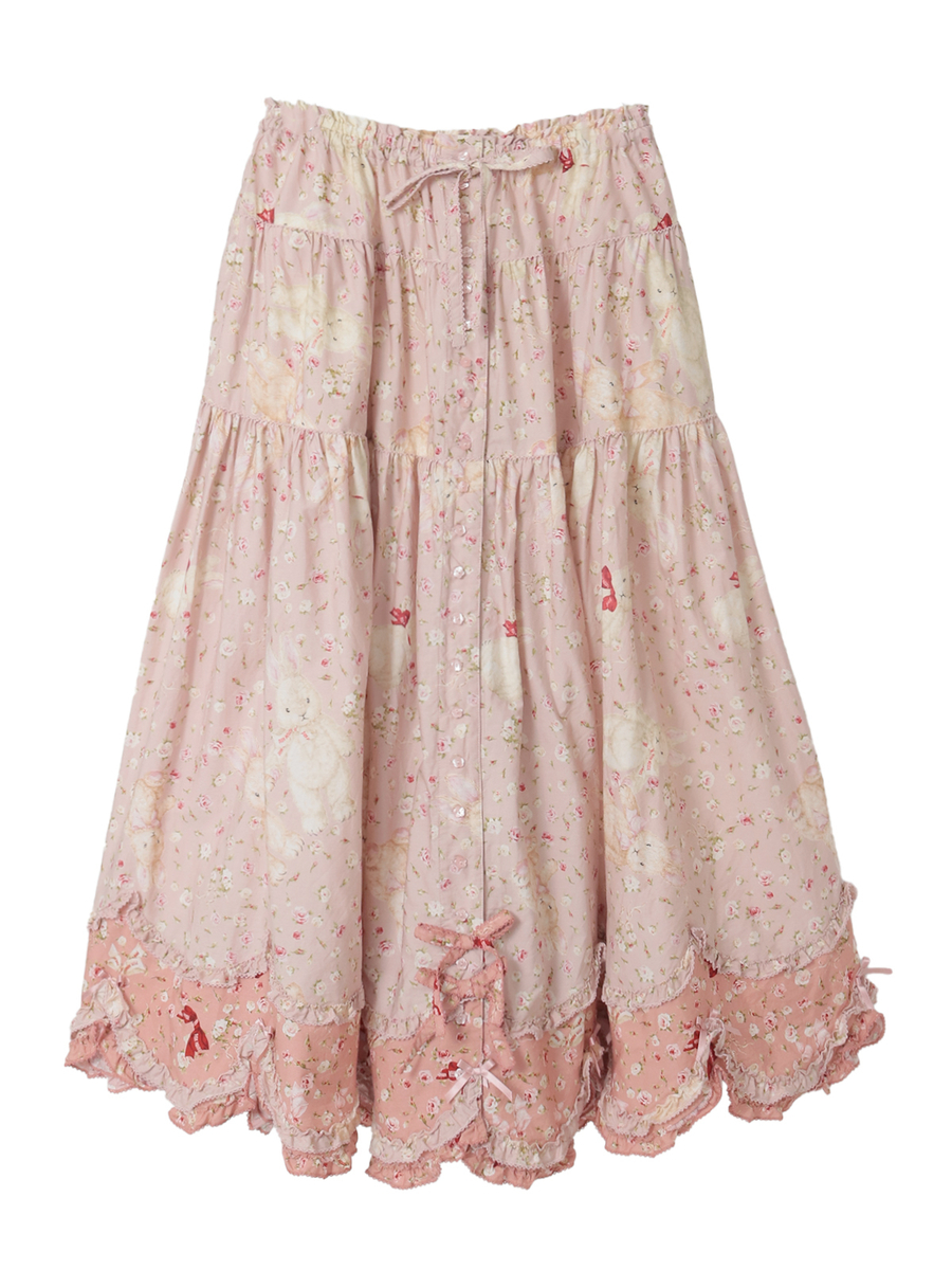 Front view of a pink women's cotton skirt with rose and rabbit print, tiered silhouette, drawstring waist and lace-trimmed hem.