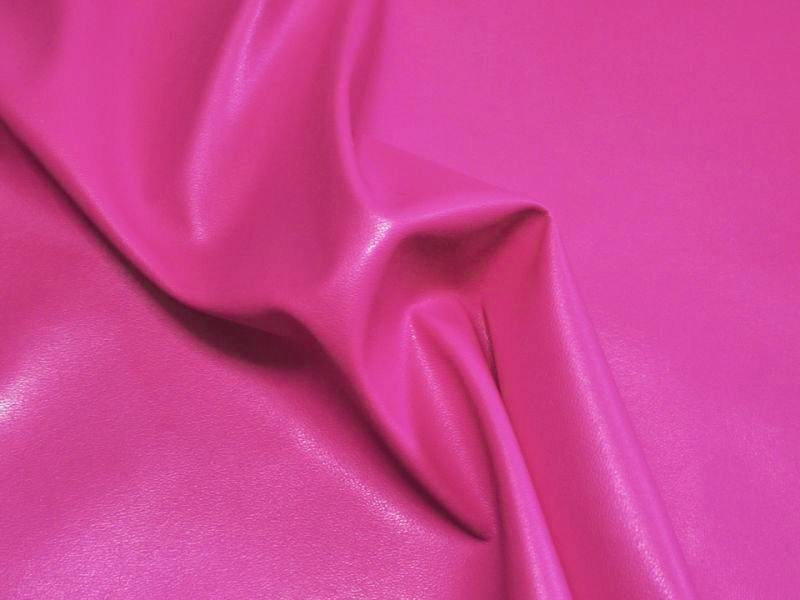 Close-up of rose-pink stretch synthetic leather (polyester) fabric with visible folds and sheen.
