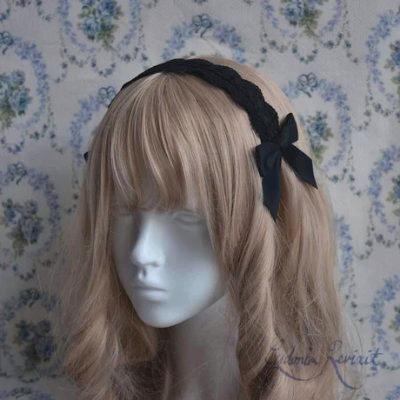 Black scalloped ladder lace headdress (decorative hairband) displayed on a white mannequin head.