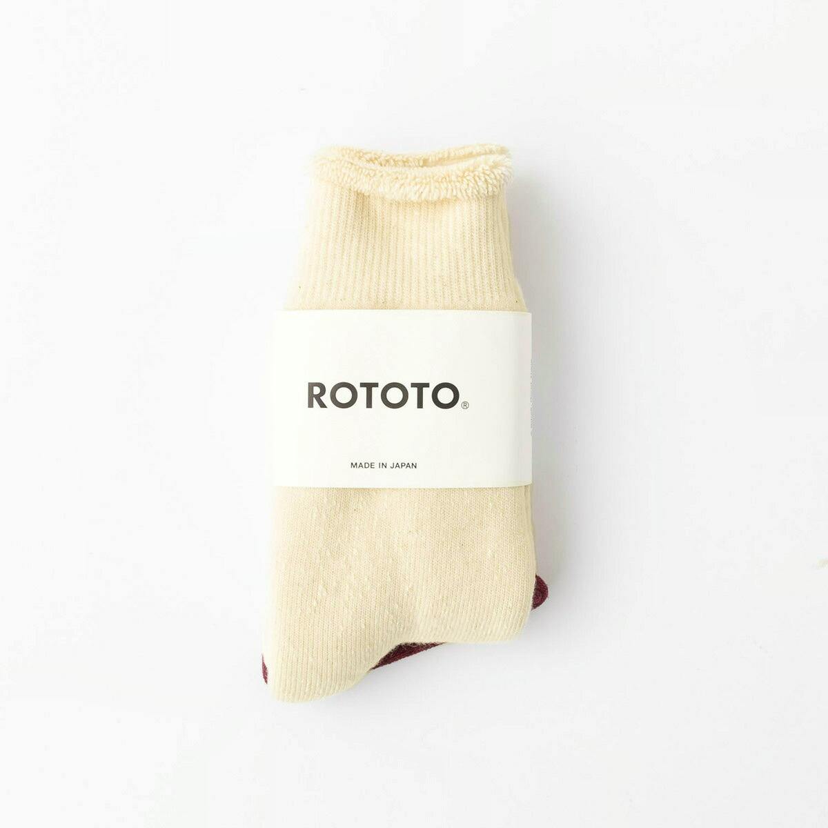 Folded cream-colored men's ROTOTO double face cotton sock with a white paper band showing the ROTOTO logo.