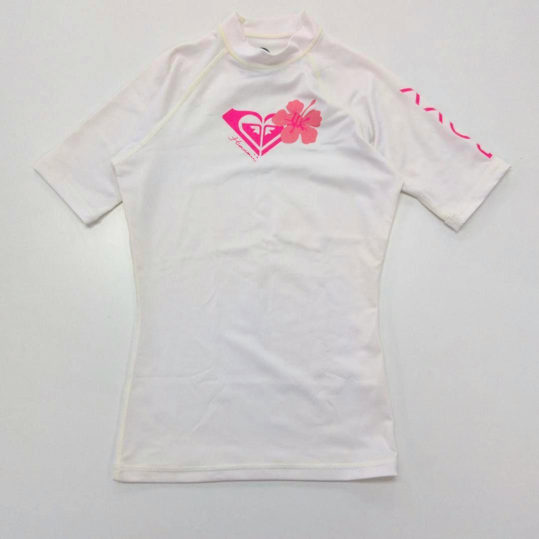 White short-sleeve ROXY rash guard laid flat showing a pink logo and hibiscus motif.
