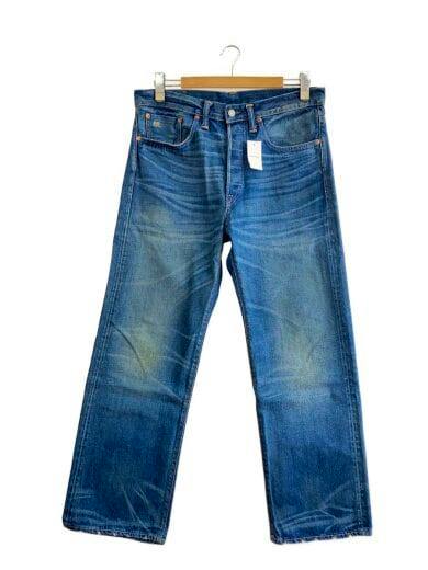 Front view of men's blue denim jeans hanging on a wooden hanger with a small tag on the waistband.