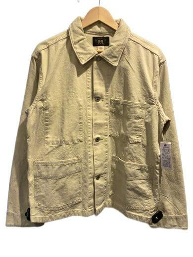 Front view of an ivory RRL cotton cover-all jacket with collar, button closure, and patch pockets on a hanger.
