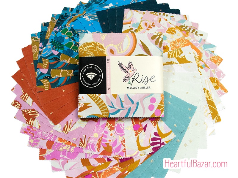 A fan of printed cotton fabric squares arranged around a wrapped bundle labeled "Rise".