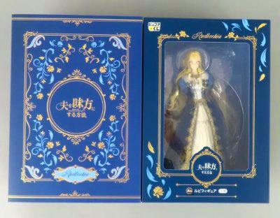 A boxed plastic figure (Ruby) visible through the front window of a blue decorative retail box.