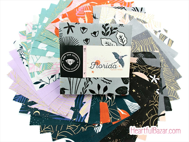 Fanned arrangement of printed cotton fabric squares from the Ruby Star Society "Florida" collection with the labeled pack in the center.