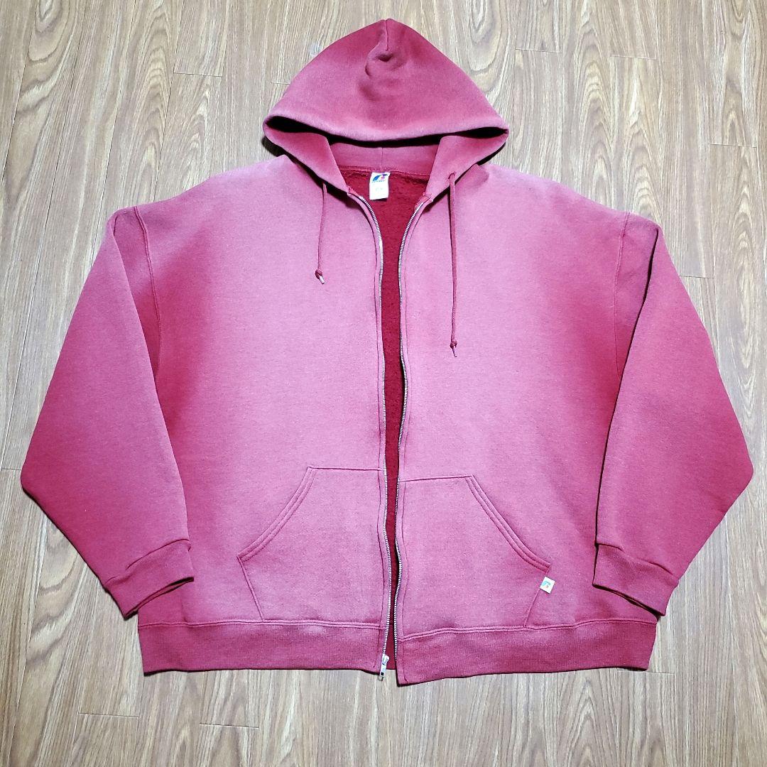 Front view of a sun-faded Russell Athletic zip hoodie laid flat showing hood, zipper, and front pockets.