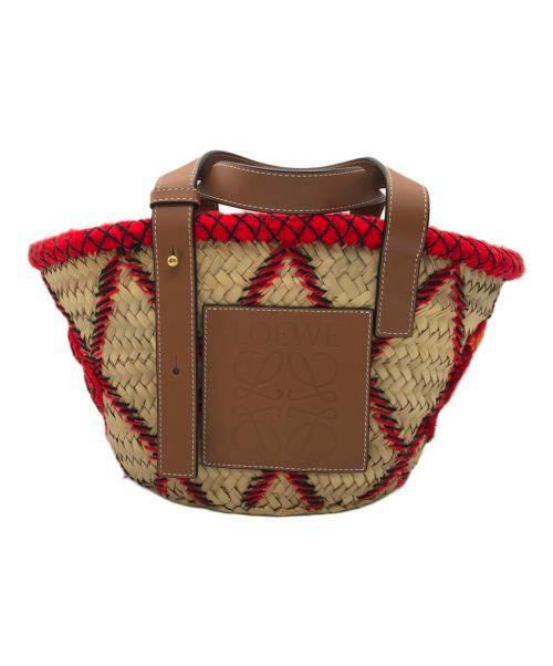 Woven basket bag with red trim, brown leather straps, and a brown leather front patch.