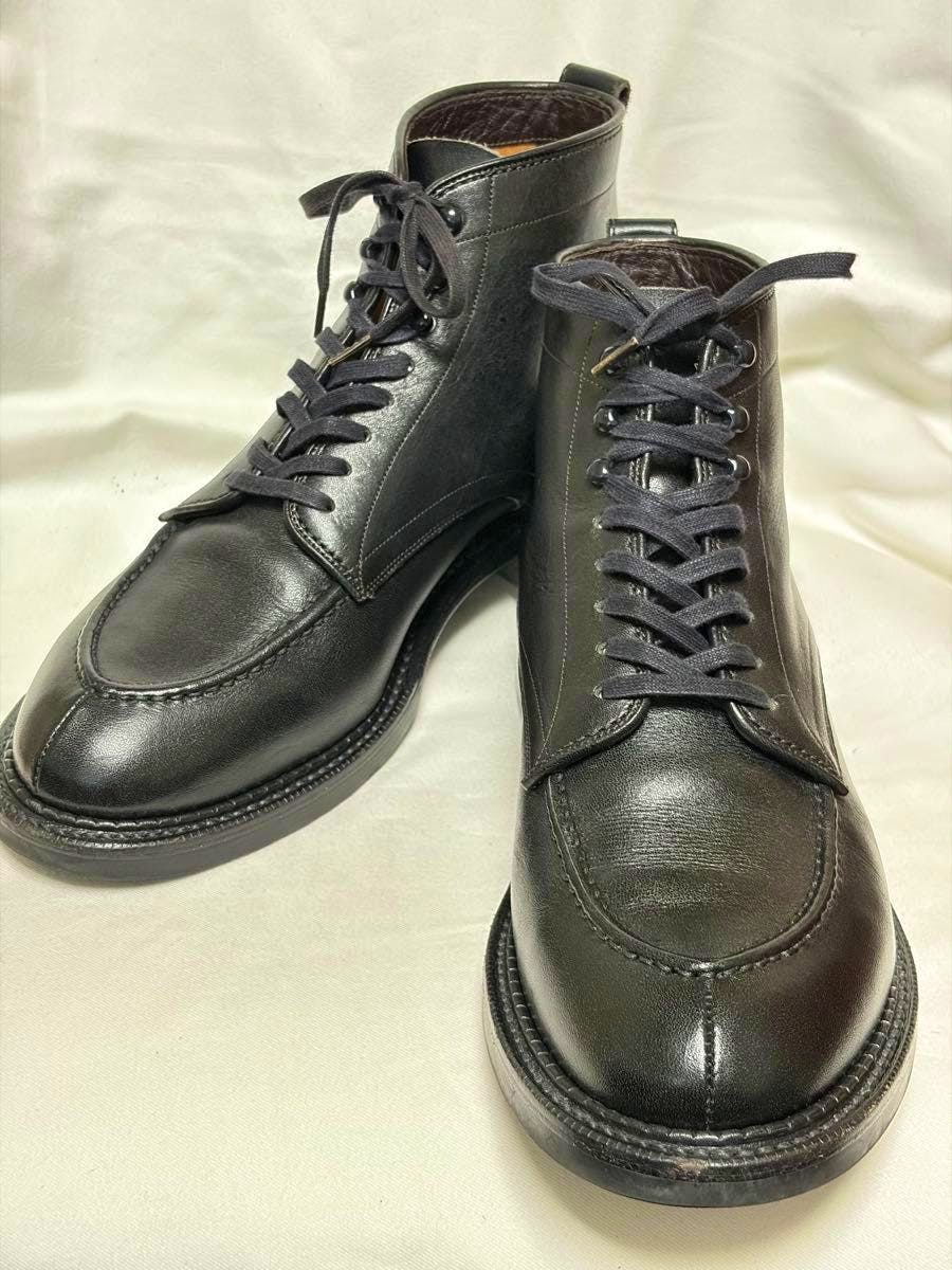 Angled front view of a pair of black leather Ruttshoes boots on a light background.
