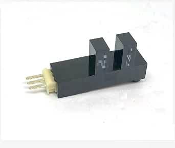 Photo interrupter repair part (Roller Ball S21) shown as a black rectangular sensor with a central slot and three metal pins on a white background.