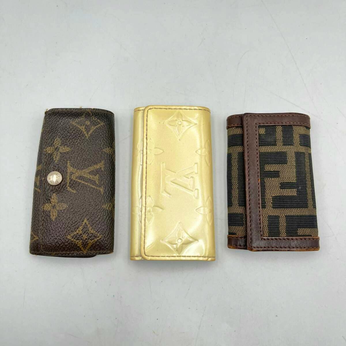 Three key cases, including Louis Vuitton monogram and a Fendi patterned case, displayed on a white surface.