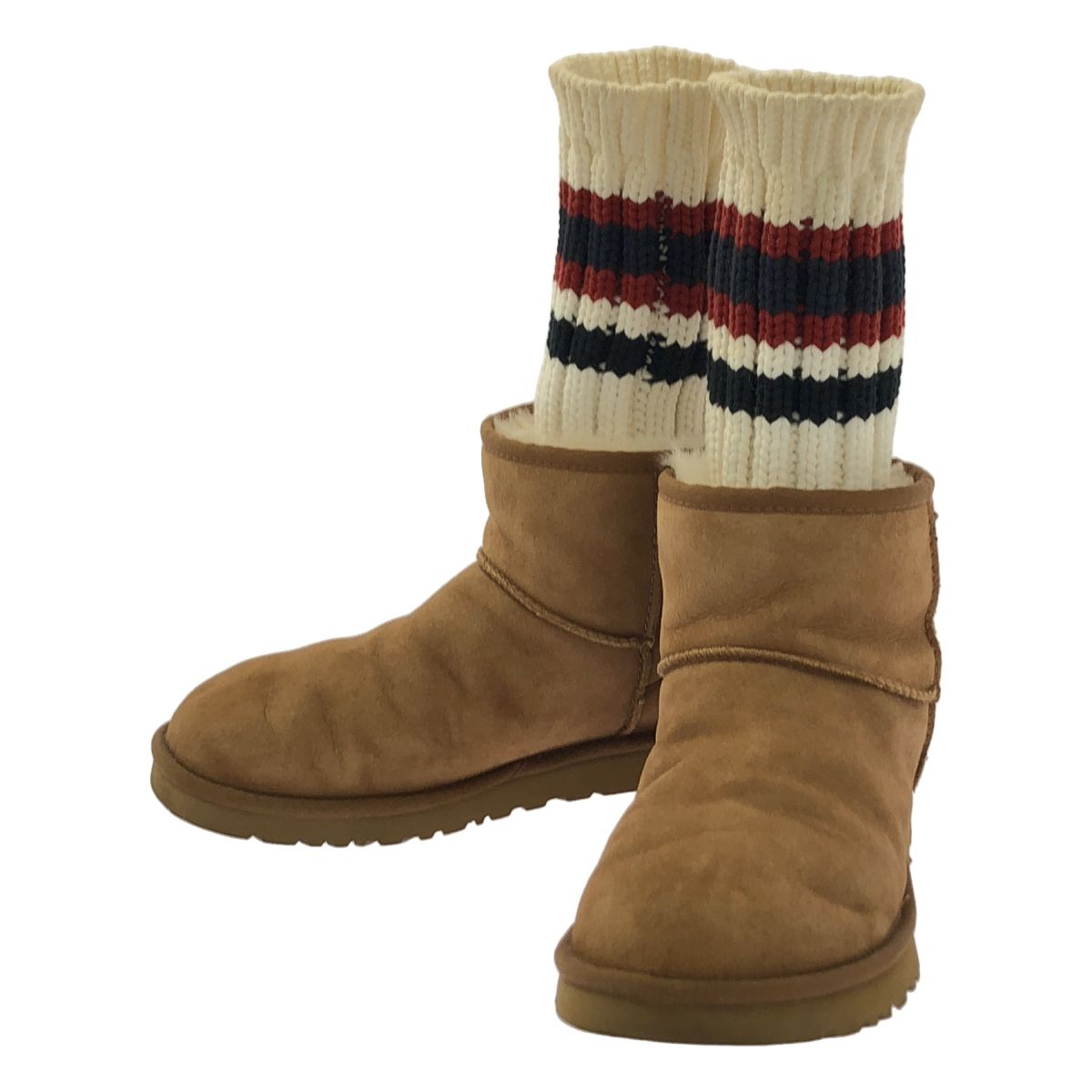 Pair of brown sacai × UGG Knit Classic Short Boots with cream ribbed knit socks attached, front three-quarter view on white background.
