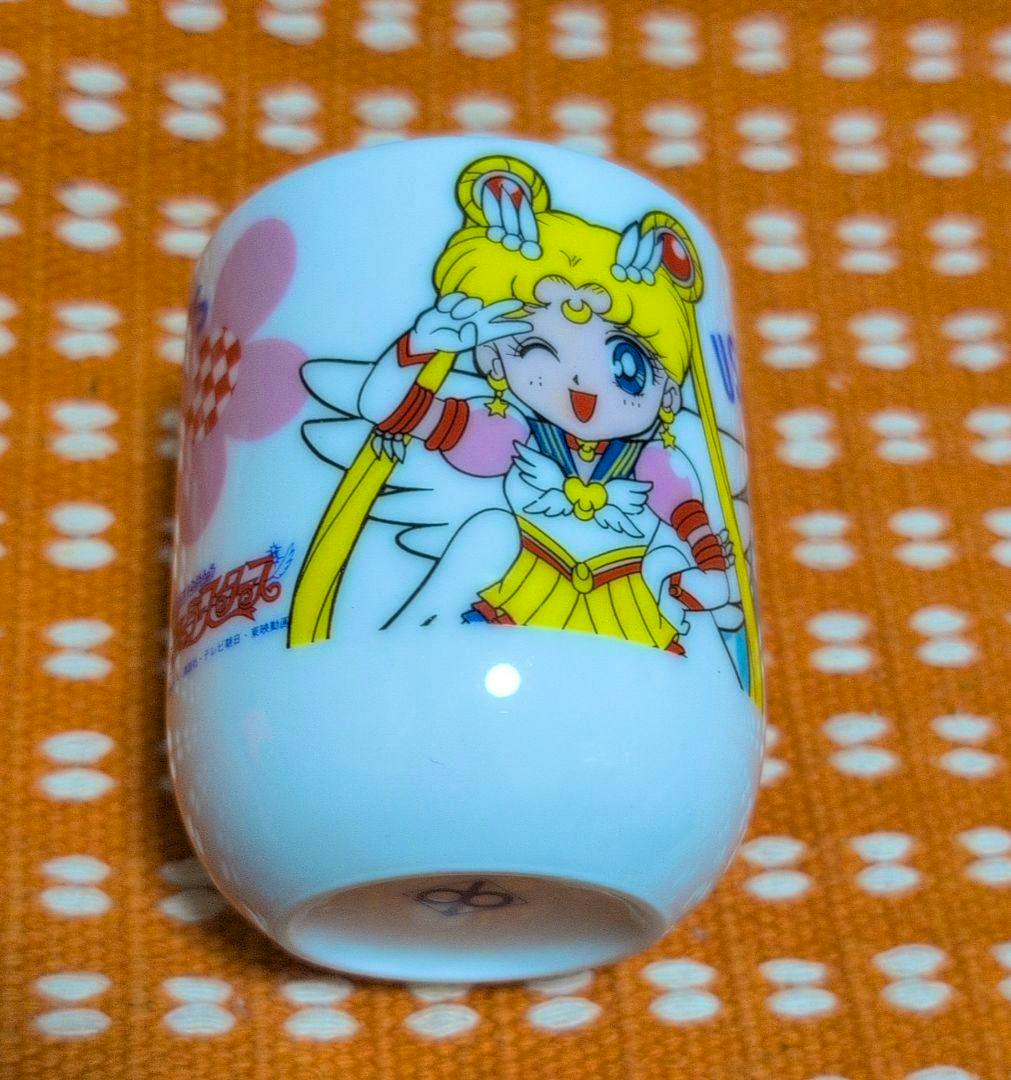 White ceramic Sailor Moon yunomi cup showing a colorful winking Sailor Moon illustration on the side.