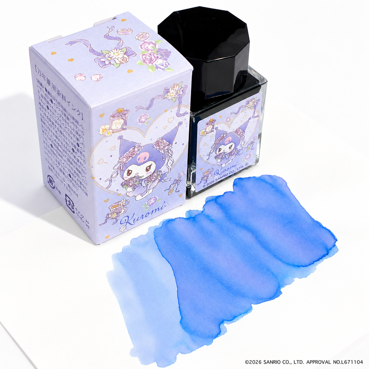 A Kuromi 20ml fountain pen ink bottle with its illustrated box and a blue ink swatch on paper.