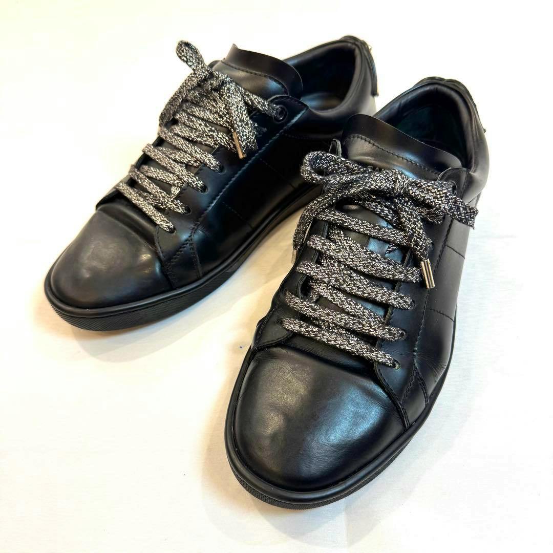 Angled top view of a pair of black Saint Laurent Court Classic sneakers showing the toe and laces.
