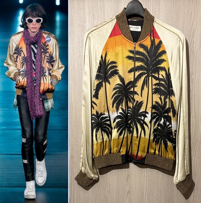 Front view of the palm-tree print rayon teddy jacket hanging on a wooden hanger against a wood background.