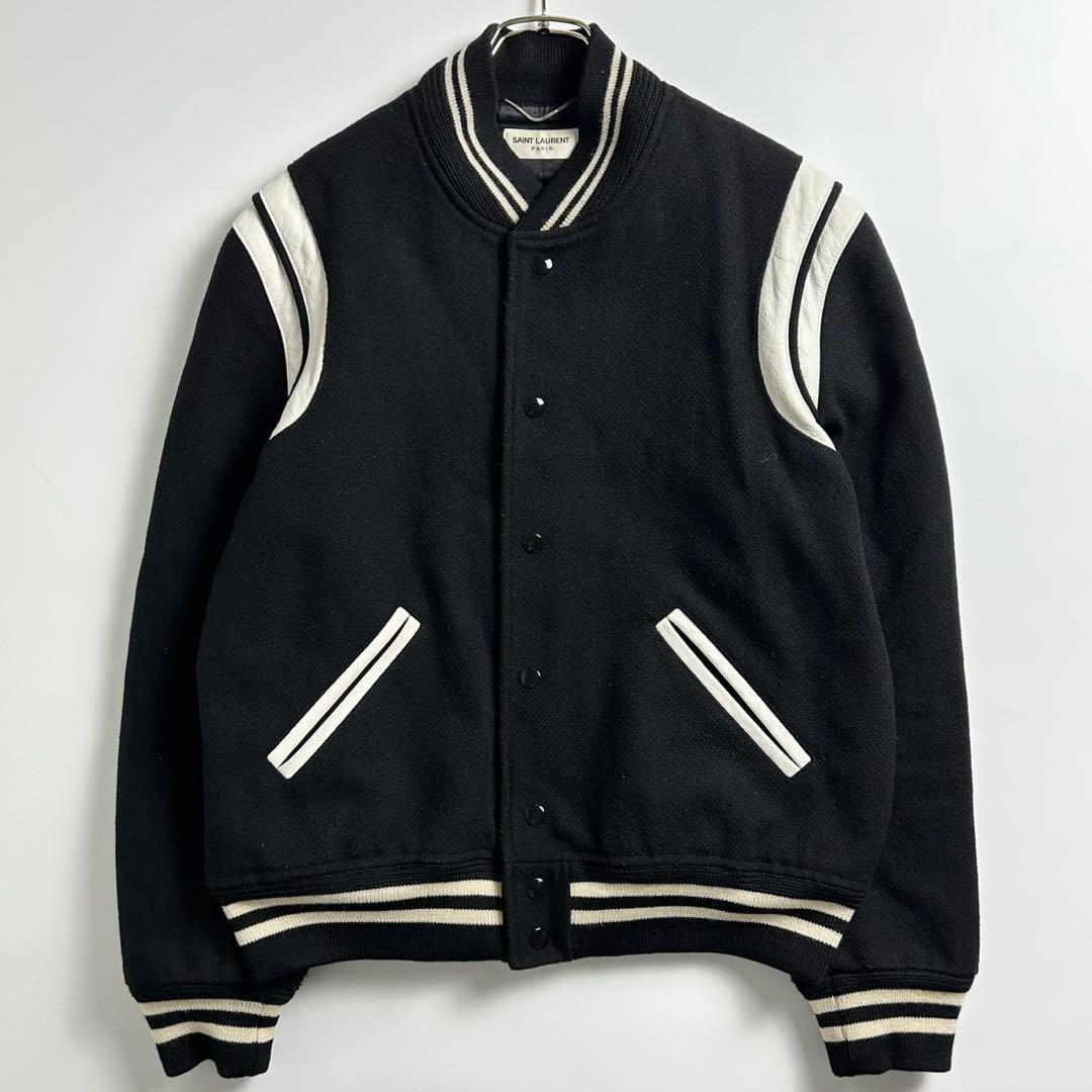 Front view of a black Saint Laurent wool teddy jacket with white striped ribbing on the collar, cuffs, hem, shoulders, and pockets.