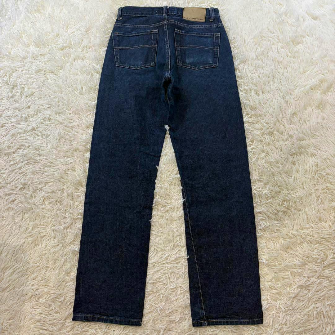 Back view of Saint Laurent vintage selvage denim men's pants (W29) laid flat showing rear pockets and full-length legs.