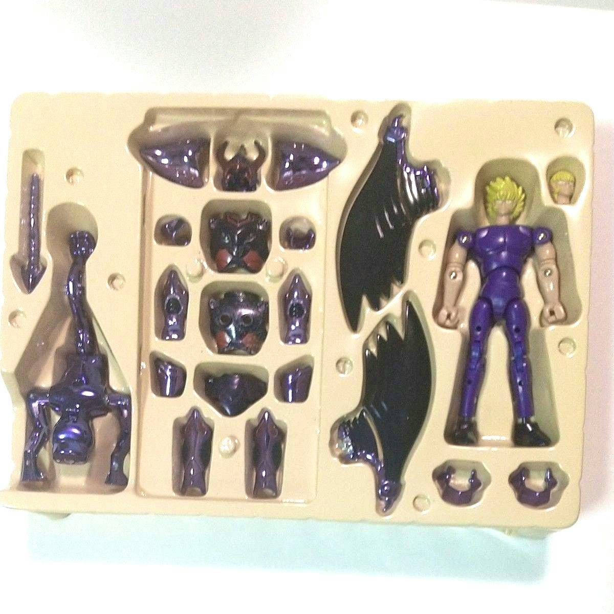 Plastic Wyvern Radamanthys figure with purple armor pieces arranged in a beige plastic tray.