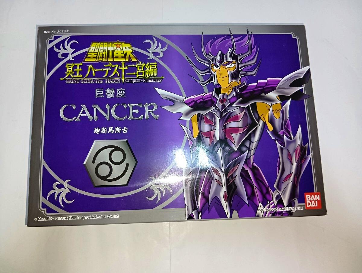 Front of the Bandai Saint Seiya Cancer figure box showing purple armored character artwork and the word "CANCER".