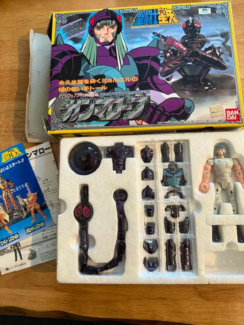 Photo of the Saint Seiya Gamma Robe (Thor) figure and its armor parts arranged in a styrofoam tray with the original Bandai box visible.