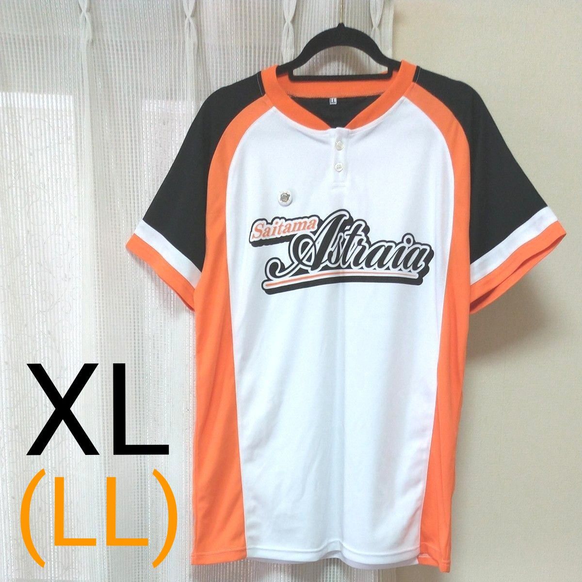 Front view of the Saitama Astraia men's polyester mesh T-shirt in white with orange and black panels, hanging on a hanger.