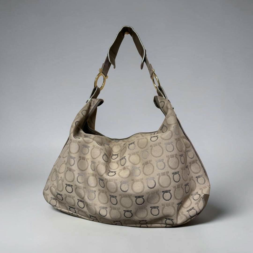 Salvatore Ferragamo canvas Gancini shoulder bag front view showing repeating Gancini pattern and gold-tone ring hardware.