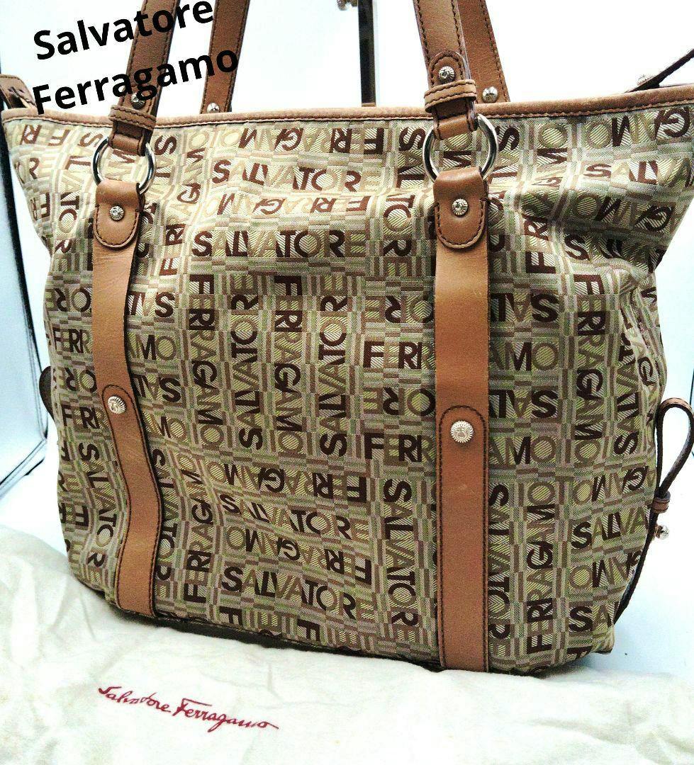 Front view of the Salvatore Ferragamo jacquard canvas handbag with tan leather straps on a dust bag.