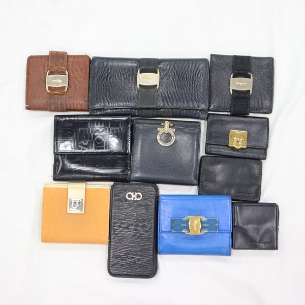 Eleven wallets and small synthetic-leather cases arranged on a white background.