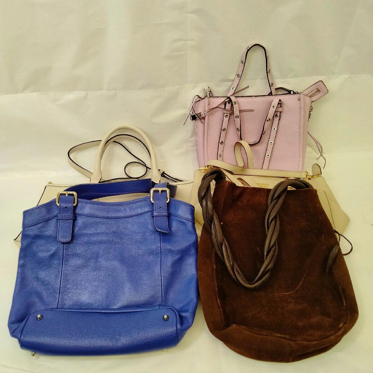 Several assorted handbags of different colors arranged on a white background.