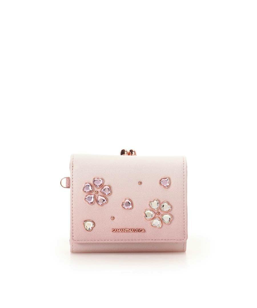Front view of a pink folding wallet with flower-shaped crystal embellishments and a Samantha Vega logo.
