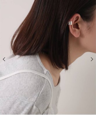Model wearing the silver wide textured ear cuff on one ear, shown from the side.