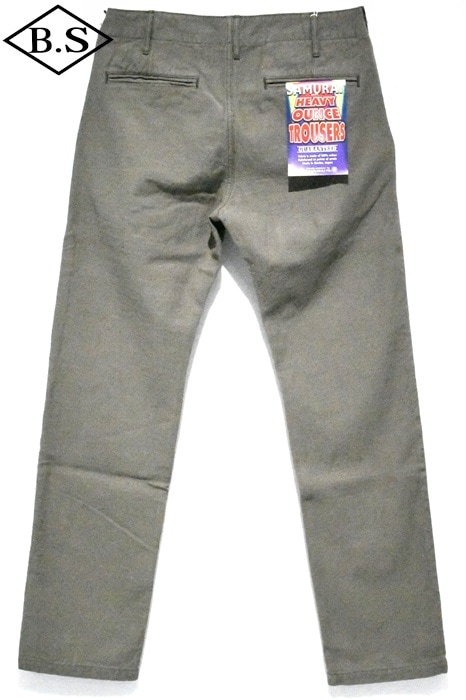 Back view of olive Samurai Jeans heavy chino trousers laid flat with a tag attached to the back pocket.