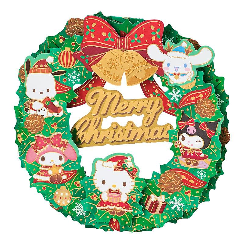 Green Christmas wreath-shaped greeting card decorated with Sanrio character illustrations and a gold "Merry Christmas" sign.