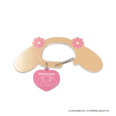 A Sanrio "Cinnamo Angels" mocha acrylic carabiner with a small metal hook and a pink heart charm.