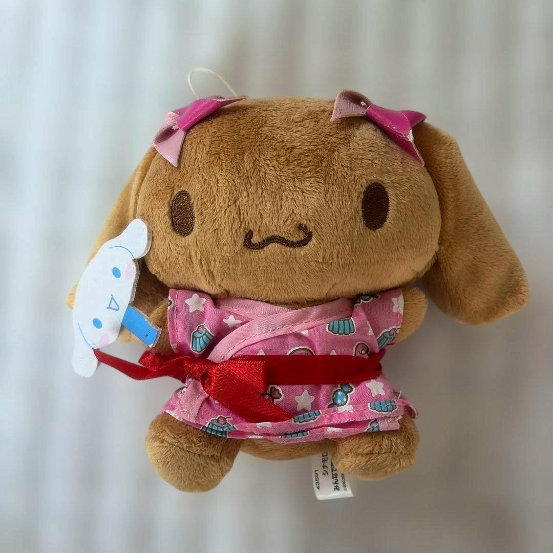 Front view of the Sanrio Cinnamoroll "Moka" 2006 plush wearing a pink summer festival yukata with a red sash and holding a small character fan.