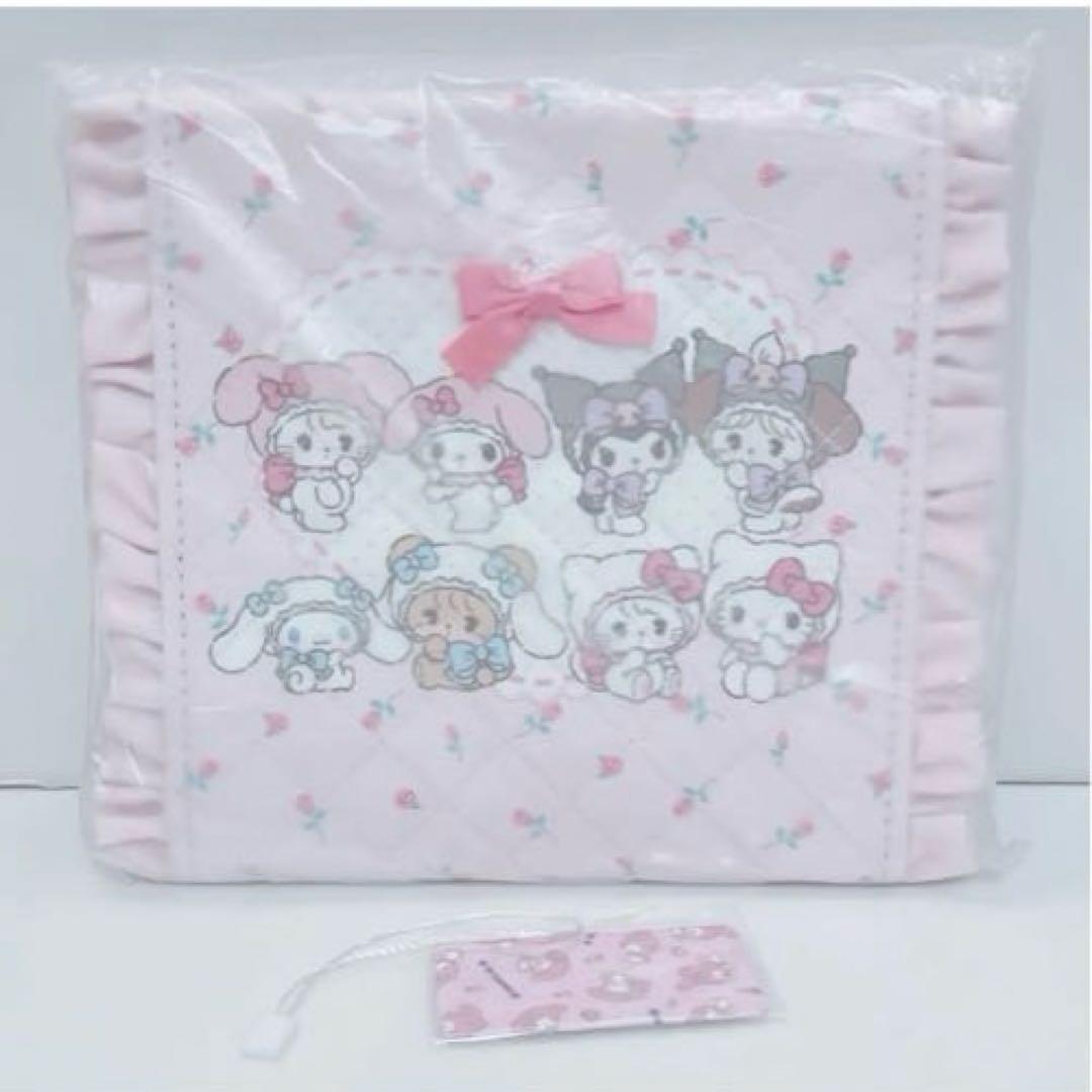 Pink quilted compact mirror featuring Hello Kitty and My Melody characters with a small pink bow and a matching tag visible in front.