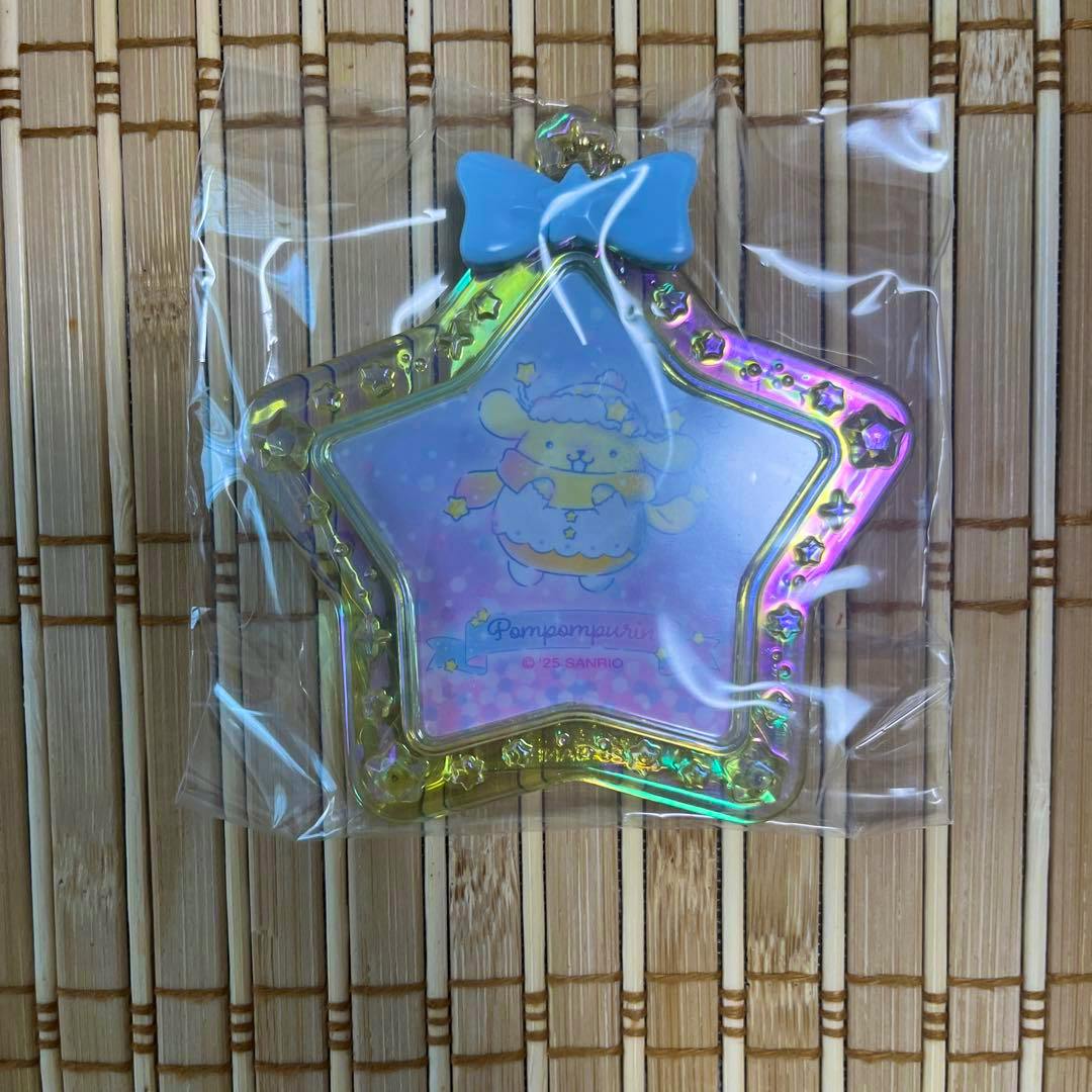 Iridescent star-shaped acrylic mini photo frame keychain showing a Pompompurin illustration, packaged in clear plastic.