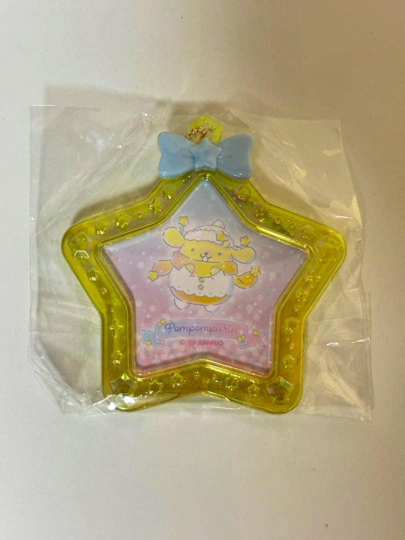 Yellow star-shaped plastic mini photo frame with a blue bow and a Pompompurin illustration, shown inside clear plastic packaging.