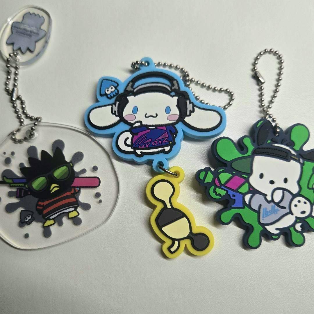 Rubber Sanrio × Splatoon keychains showing Cinnamoroll, Badtz-Maru, Pochacco, and a small yellow charm laid on a white background.
