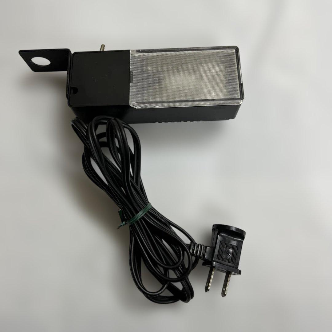 A Sansui SL-10 audio lamp shown with its attached power cord and two-prong plug on a white background.