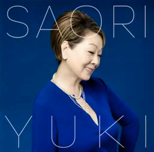 CD cover showing a woman in a blue top posing against a blue background with large white text.