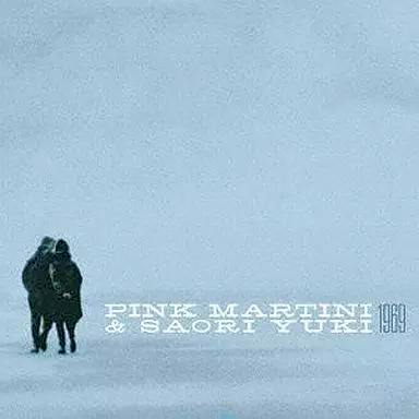 CD cover art showing two people walking across a pale blue snowy landscape with the text "PINK MARTINI & SAORI YUKI 1969".