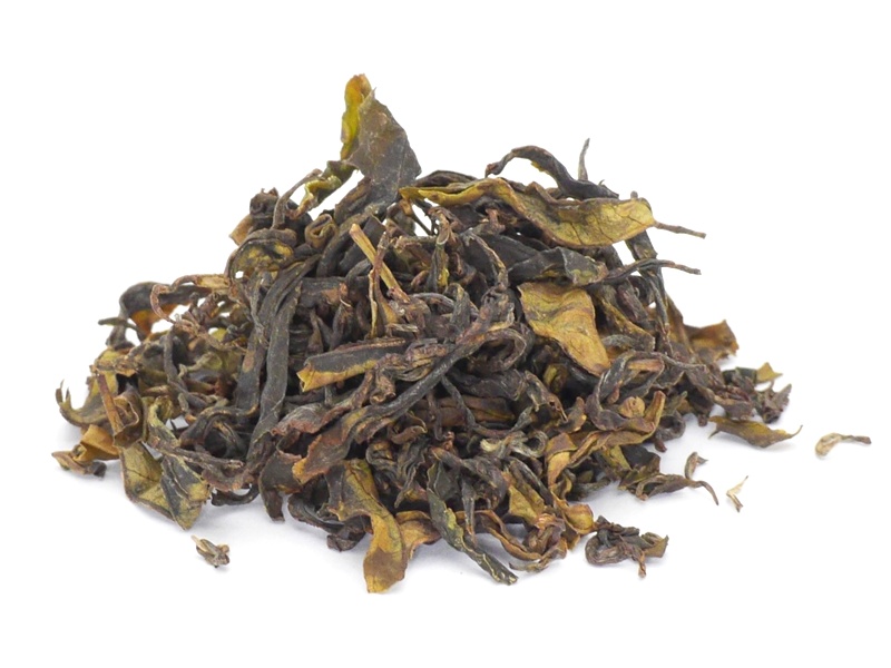 A pile of loose-leaf black tea displayed on a white background.