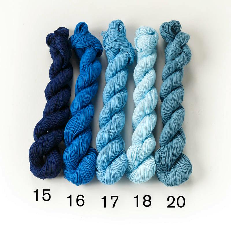 Five skeins of blue cotton sewing thread labeled 15, 16, 17, 18, and 20 arranged side by side on a white background.