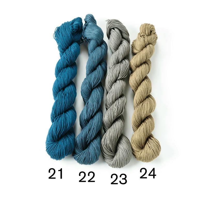 Four skeins of sashiko cotton sewing thread numbered 21–24 are arranged side by side on a white background.