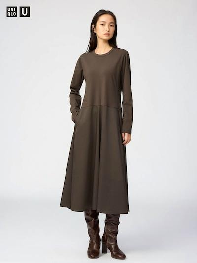Female model wearing the brown long-sleeve satin-combination one-piece dress shown facing forward.