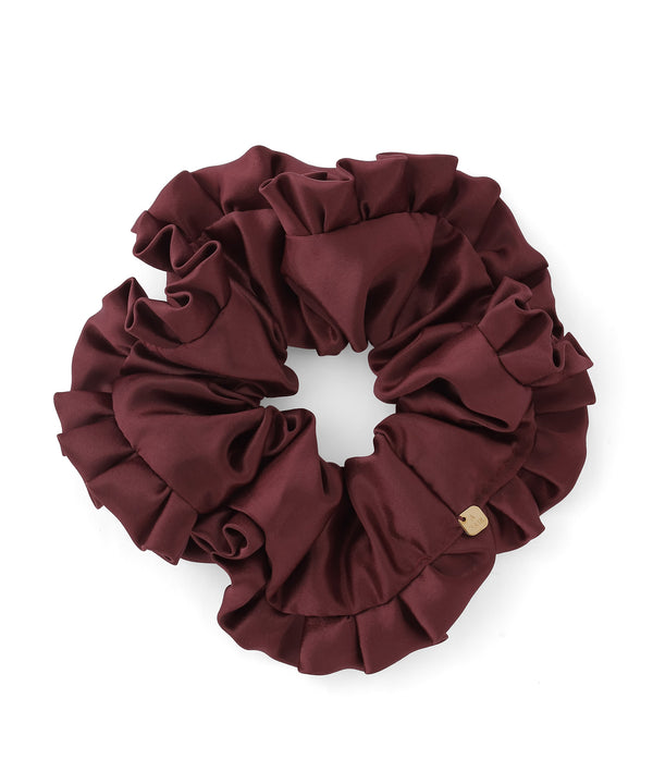 Burgundy satin frill hair scrunchie photographed on a white background.