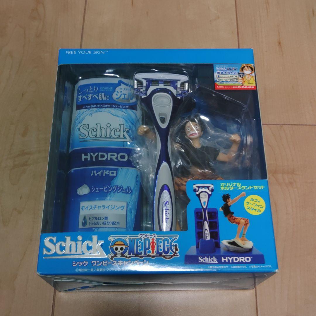 Retail boxed Schick Hydro razor holder set with shaving gel and a One Piece figurine visible through the packaging.